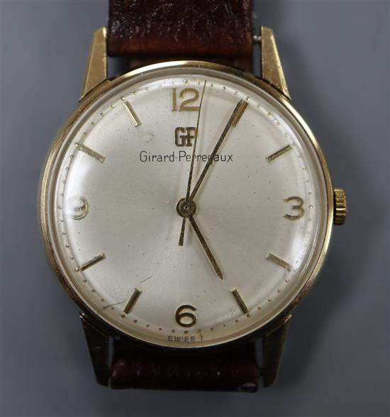 A gentlemans 9ct gold Girard Perregaux manual wind wrist watch, with associated leather strap, with Perregaux box.